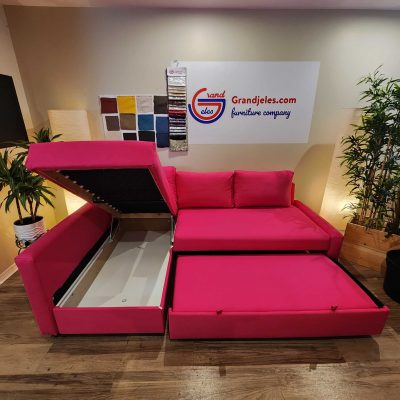 Pink L-shaped sofa bed with dual storage compartments open